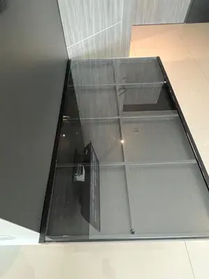a glass shelf on a wall in a room at Utopia Central in Ban Ket Ho