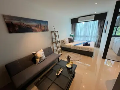 a living room with a couch and a bed at Utopia Central in Ban Ket Ho