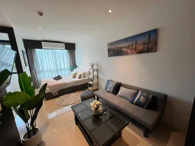 a living room with a couch and a bed at Utopia Central in Ban Ket Ho