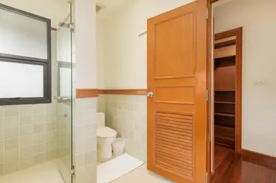a bathroom with a glass shower and a toilet at Spacious Villa with Pool, Garden & Club facilities in Layan Beach