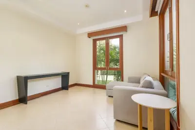 a living room with a couch and a table at Spacious Villa with Pool, Garden & Club facilities in Layan Beach