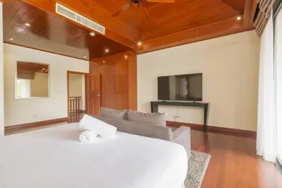 a living room with a white bed and a couch at Spacious Villa with Pool, Garden & Club facilities in Layan Beach