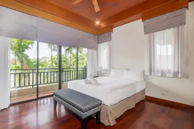 a bedroom with a bed and a large window at Spacious Villa with Pool, Garden & Club facilities in Layan Beach