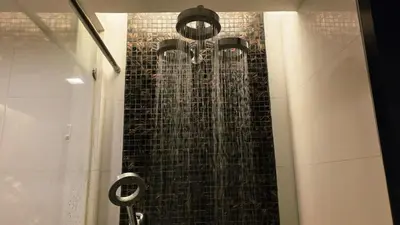 a shower with water coming out of the wall at Beautiful Pool View Studio in Kata in Kata Beach