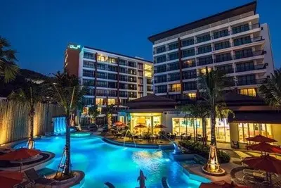 a hotel with a swimming pool in front of a building at Beautiful Pool View Studio in Kata in Kata Beach