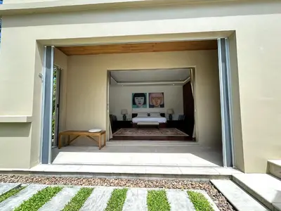 a view of a bedroom from the outside of a house at Luxury Pool Villa Bangtao Phuket close to beach in Bang Tao Beach