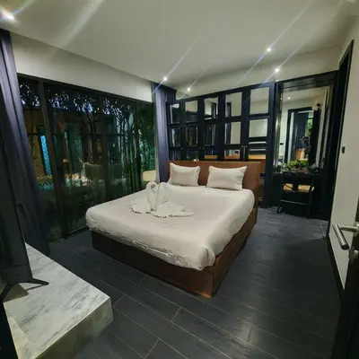a bedroom with a bed with a towel on it at Chalong Modern 2 bedroom pool villa in Ban Suan
