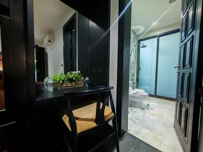 a bathroom with a black counter and a toilet at Chalong Modern 2 bedroom pool villa in Ban Suan