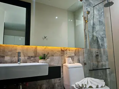 a bathroom with a sink and a shower and a toilet at Chalong Modern 2 bedroom pool villa in Ban Suan
