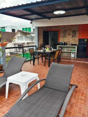 a patio with chairs and a table and a kitchen at Kata Lina rooftop in Kata Beach