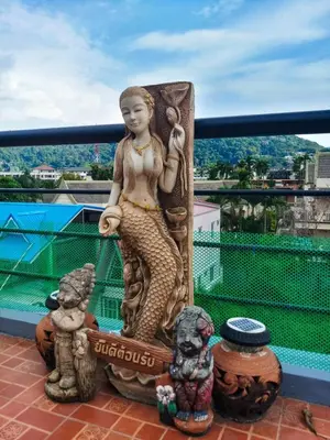 a statue of a mermaid on a balcony at Kata Lina rooftop in Kata Beach