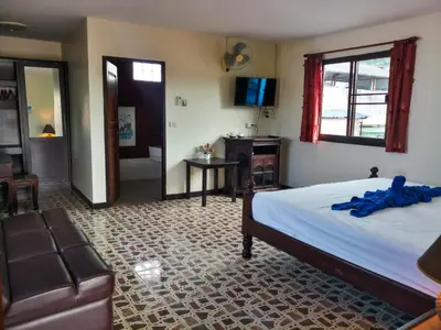 a bedroom with a bed and a living room at Kata Lina rooftop in Kata Beach