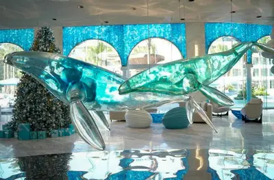 a large glass airplane sitting in a room with a christmas tree at Sunshine Layan Beach Resort studio #84191 in Layan Beach