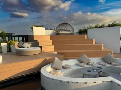 a deck with a hot tub on top of a building at Sunshine Layan Beach Resort studio #84191 in Layan Beach