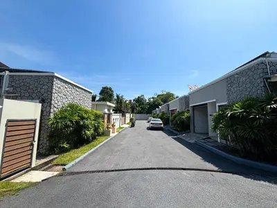 a street with a car parked on the side of a house at Tropical 2 BR Pool Villa - Baan Wana 177-15 in Koh Lone