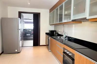 a kitchen with a refrigerator and a sink at Tropical 2 BR Pool Villa - Baan Wana 177-15 in Koh Lone
