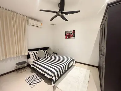 a bedroom with a bed and a ceiling fan at Tropical 2 BR Pool Villa - Baan Wana 177-15 in Koh Lone