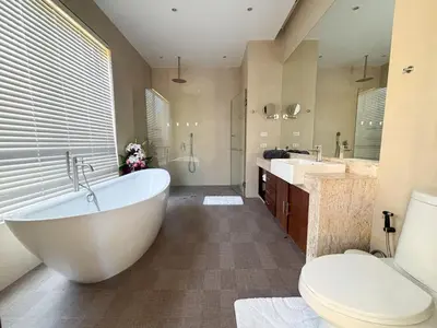 a bathroom with a tub and two sinks and a toilet at Tropical 2 BR Pool Villa - Baan Wana 177-15 in Koh Lone