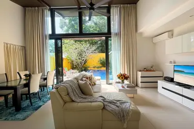 a living room with a couch and a table at Tropical 2 BR Pool Villa - Baan Wana 177-15 in Koh Lone