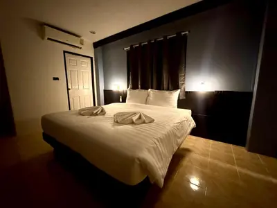 a bedroom with a bed with two towels on it at Chapter 26 in Patong Beach