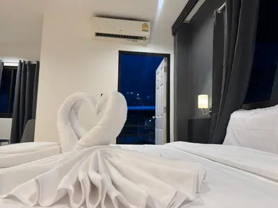 two white swans making a heart on a bed at Chapter 26 in Patong Beach