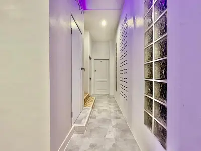 a hallway with white walls and a white door at Jasmine Residence in Patong Beach