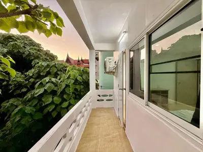 a balcony of a house with a large plant at Jasmine Residence in Patong Beach