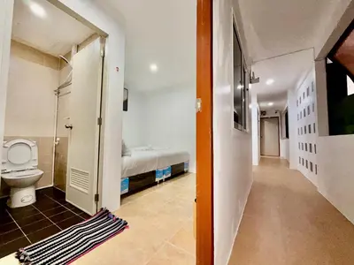 a bathroom with a bed and a toilet in a room at Jasmine Residence in Patong Beach