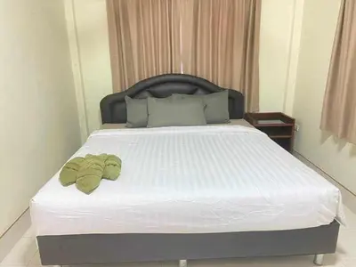 a bedroom with a bed with two towels on it at Karon cottage Resort 2 Bedrooms Vl and BBQ in Karon Beach