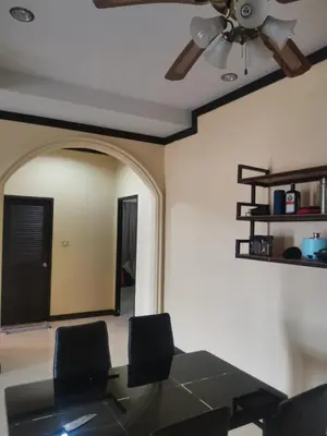a dining room with a table and a ceiling fan at Karon cottage Resort 2 Bedrooms Vl and BBQ in Karon Beach