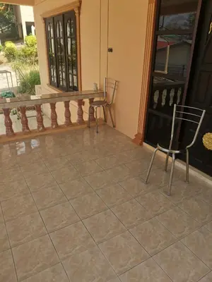 a patio with two chairs and a table on a porch at Karon cottage Resort 2 Bedrooms Vl and BBQ in Karon Beach