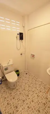 a bathroom with a toilet and a sink at Tiger Nanai guest house in Patong Beach