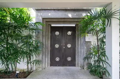 a wooden door with plants in front of it at Private villa at Oxygen Bangtao -pool garden BBQ in Ban Thalat Choeng Thale