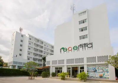 a white building with a sign on it at Recenta Suite Phuket Suanluang in Phuket Town