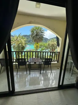 a view of a balcony with a table and chairs at Nanworld travel sea view room in Phi Phi Don