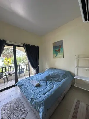 a bedroom with a bed and a large window at Nanworld travel sea view room in Phi Phi Don