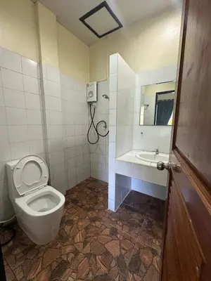 a bathroom with a toilet and a sink and a mirror at Nanworld travel sea view room in Phi Phi Don