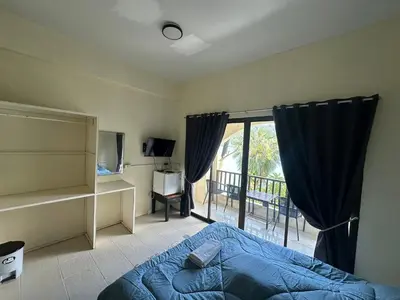 a bedroom with a bed and a large window at Nanworld travel sea view room in Phi Phi Don