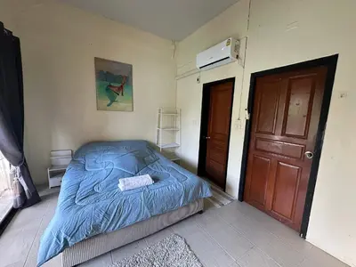 a bedroom with a bed with a blue comforter at Nanworld travel sea view room in Phi Phi Don