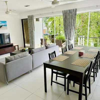 a living room with a table and chairs and a couch at Kamala Hills Ocean Breeze 3 Bedroom Loft with Access to 3 Pools in Kamala Beach