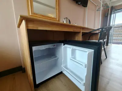 an empty refrigerator in a kitchen with a counter at Yolo\u6d77\u9493\u4ff1\u4e50\u90e8\u516c\u5bd3 in Ban Bang Chak