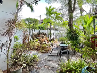 a patio with a table and chairs and plants at Cozy Serene Home Quiet Garden for a Peaceful Stay in Phuket Town