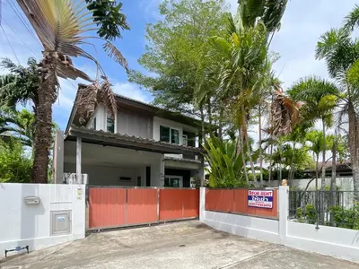 a house with a gate and palm trees at Cozy Serene Home Quiet Garden for a Peaceful Stay in Phuket Town