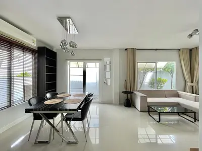 a living room with a table and a couch at Cozy Serene Home Quiet Garden for a Peaceful Stay in Phuket Town
