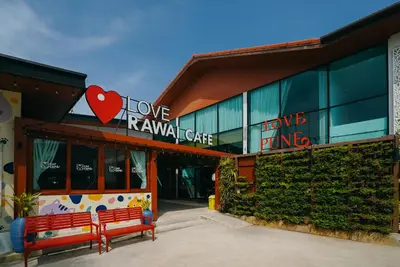 a building with a red bench in front of it at Rawayana West Villas & Kids Park in Rawai Beach
