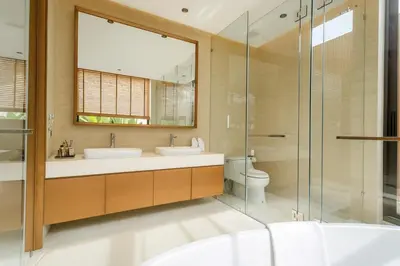 a bathroom with two sinks and a glass shower at The White Courtyard Sanctuary 4BR Pool Viila in Koh Lone