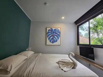 a bedroom with a bed and a large window at Urban Chill -1 Bedroom (T2-216) in Phuket Town