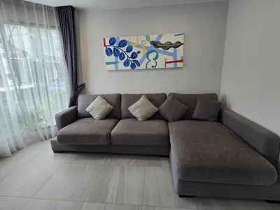 a living room with a brown couch in front of a window at Urban Chill -1 Bedroom (T2-216) in Phuket Town