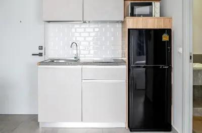 a kitchen with a black refrigerator and a sink at Charming 1-Bed Apt (T3- 629) in Phuket Town