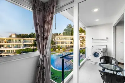 a balcony with a view of a pool at Karon Sea View 2 Bedrooms Apartment in Karon Beach